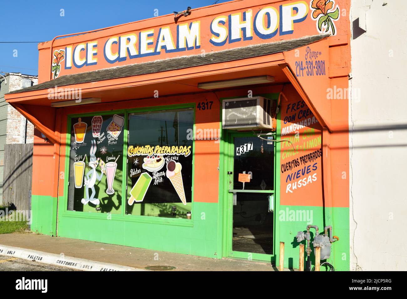 A colorful orange and green painted ice cream shop in the Oak Cliff