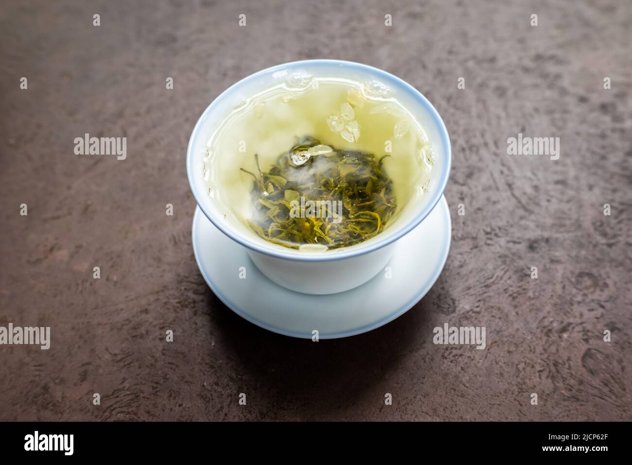 Cup of green tea on a stone table close-up view Stock Photo
