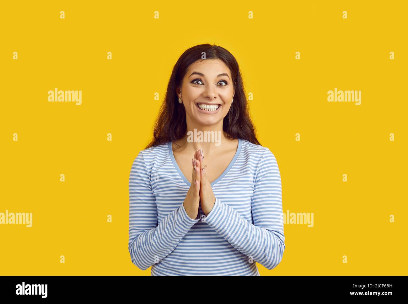 Happy excited woman waiting for surprise, smiling and rubbing hands in anticipation Stock Photo