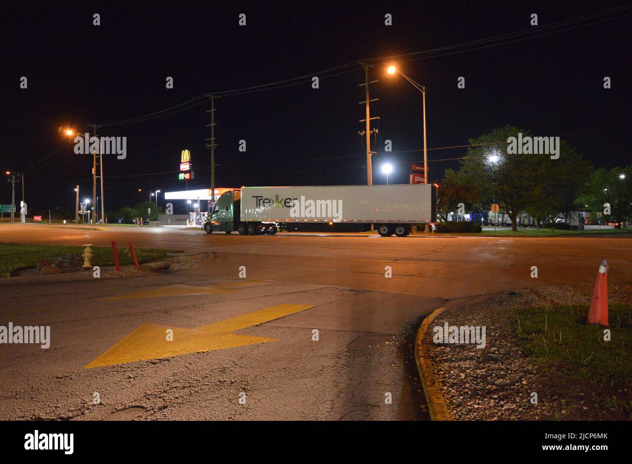 Night time photo of a Trekker semitruck trailer exiting a truck stop