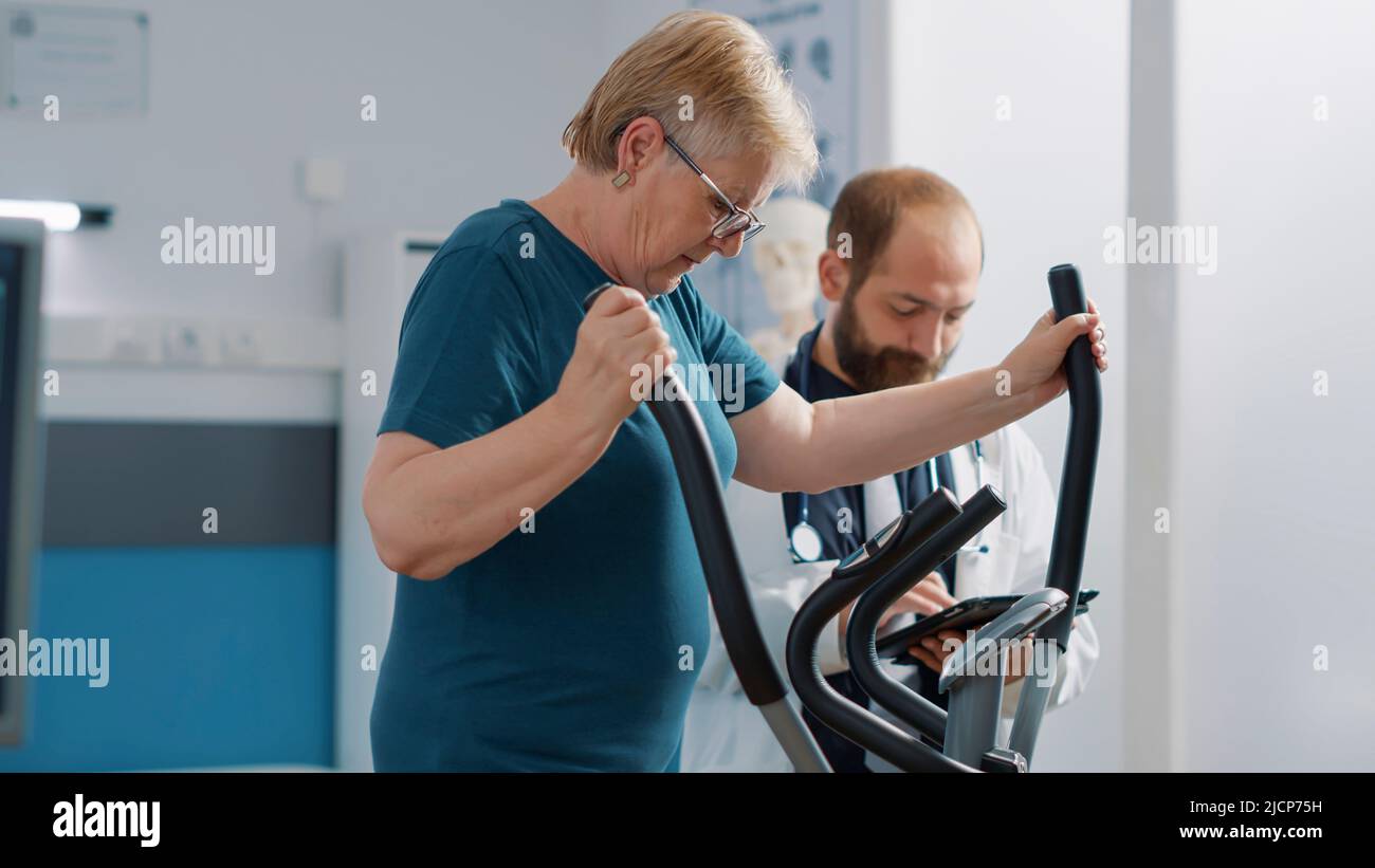 Senior patient doing recovery exercise at appointment with