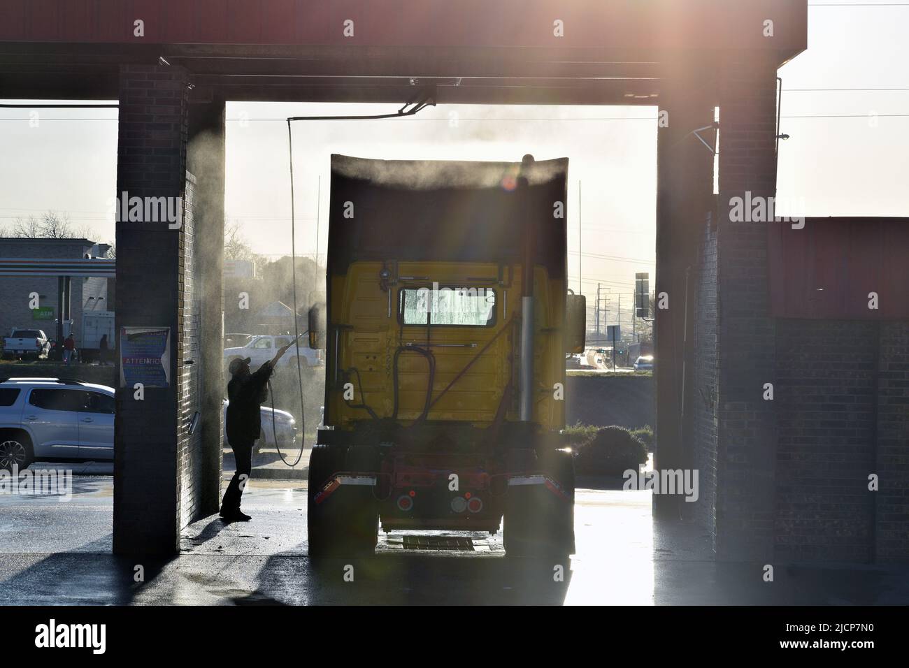 Man washing a semi-truck cab in the early morning at a truck wash in Irving, Texas Stock Photo