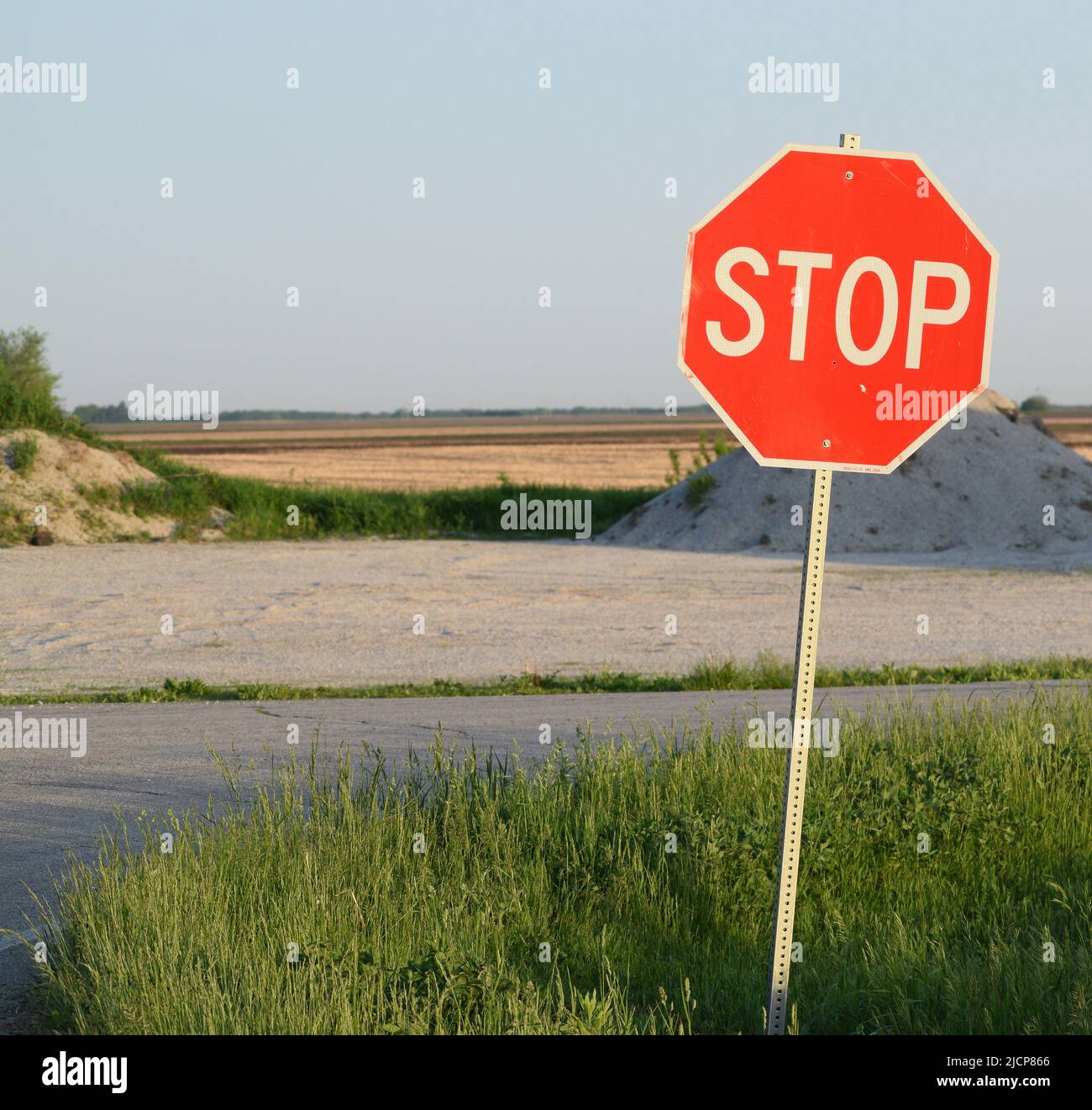 Stop sign on the right side of an image, sky in the background Stock