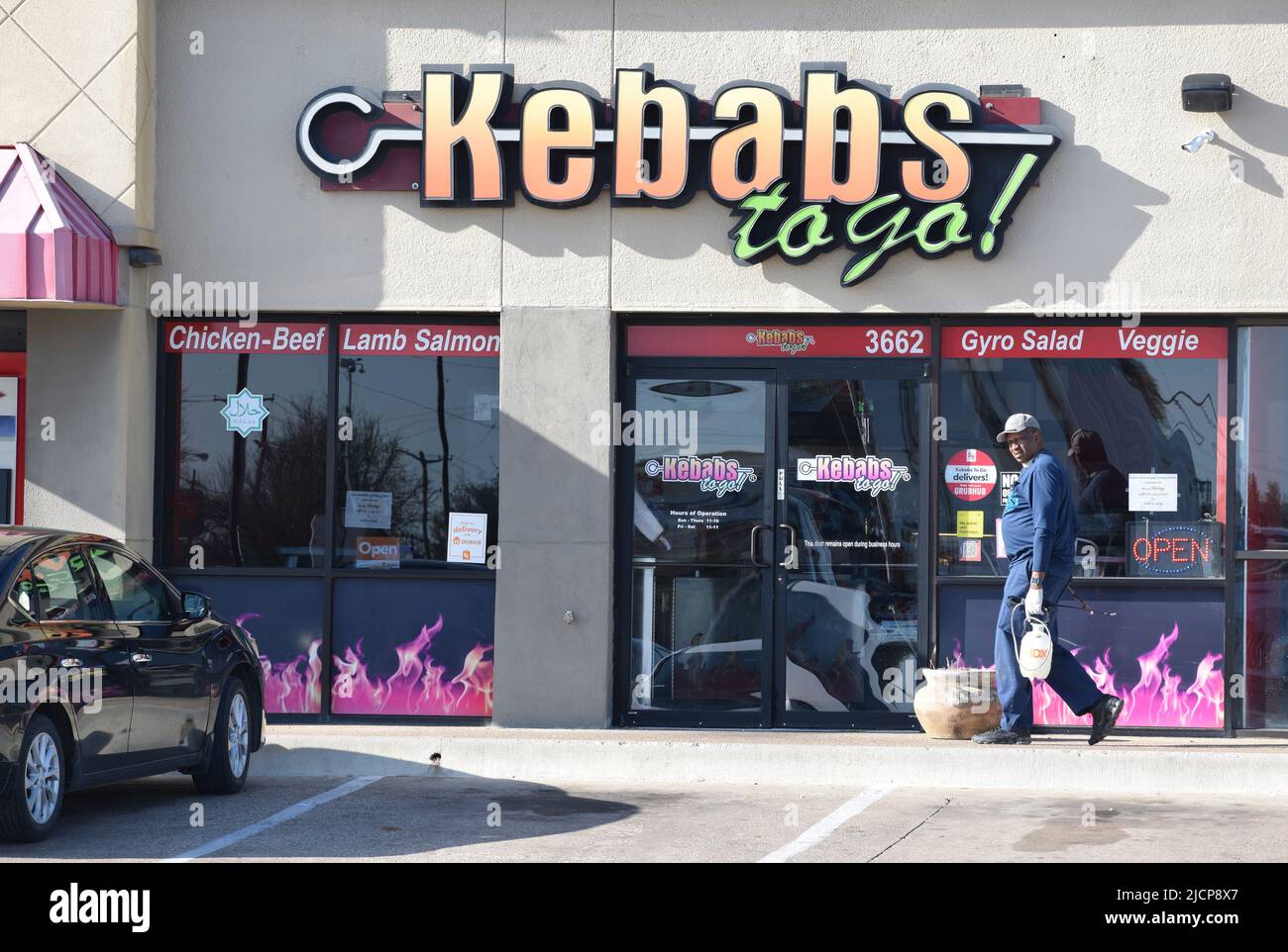 Bug exterinator walking in front of a Kebabs to Go store in Irving, Texas Stock Photo