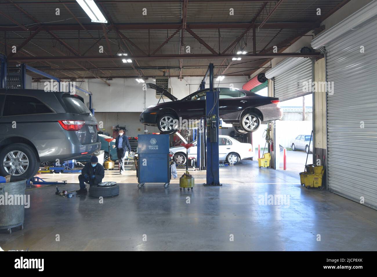 Cars on a rack or hydraulic lift in an auto repair shop, mechanic ...