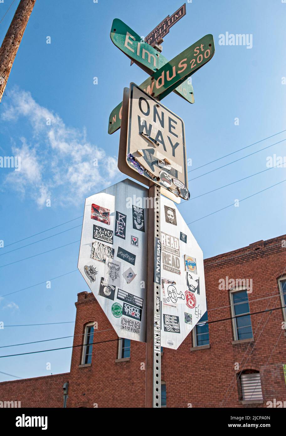 Deep Ellum Area of Dallas, Texas: Stickers adorn the back of a stop sign at the corner of Elm and Crowdus streets Stock Photo