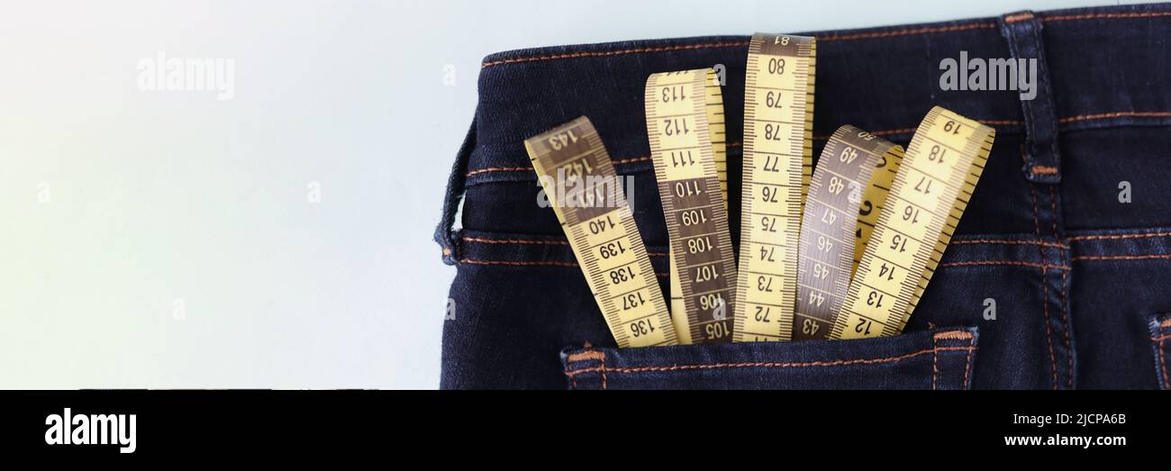 Yellow measuring tape in jeans pocket image of body slimming Stock Photo