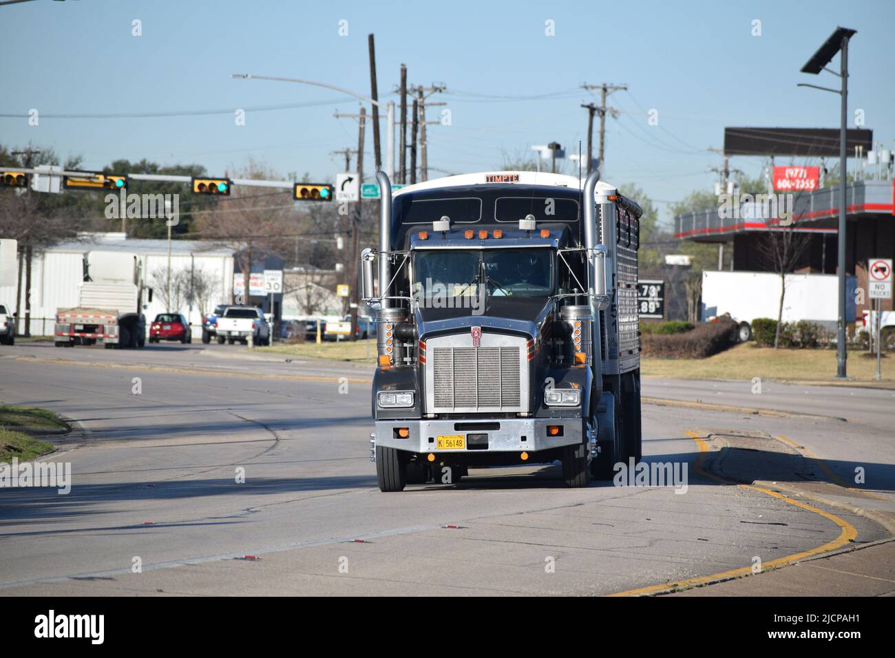 A black Kenworth Semitruck cab with Arkansas license plates, facing
