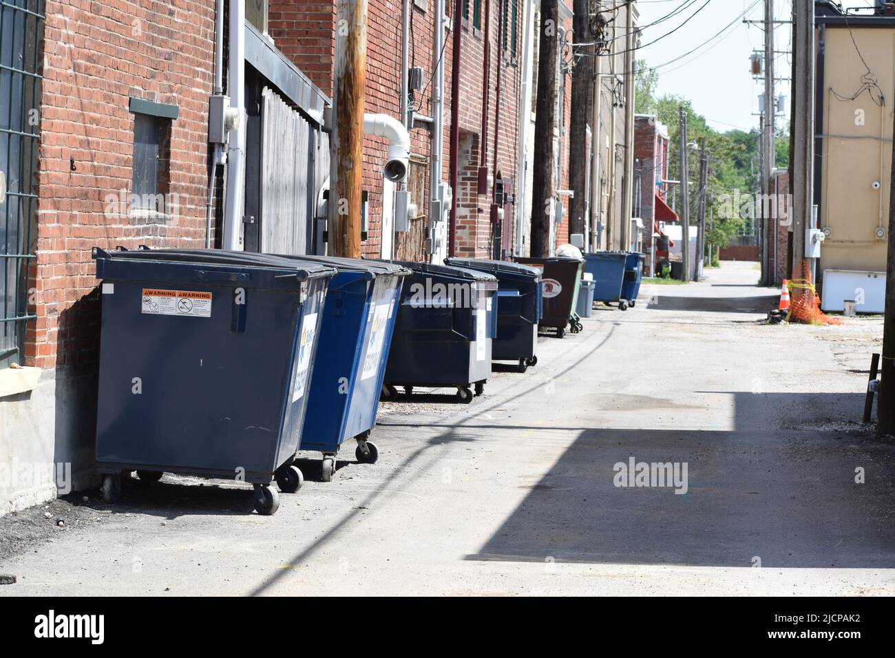 Trash dumpsters in an alley in Hannibal Missouri Stock Photo