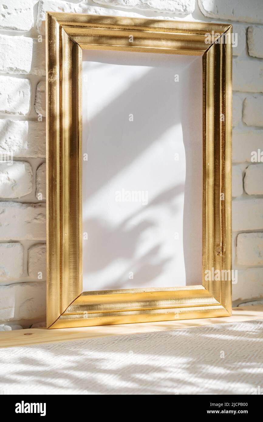 Photo frames on floor over white brick wall Stock Photo