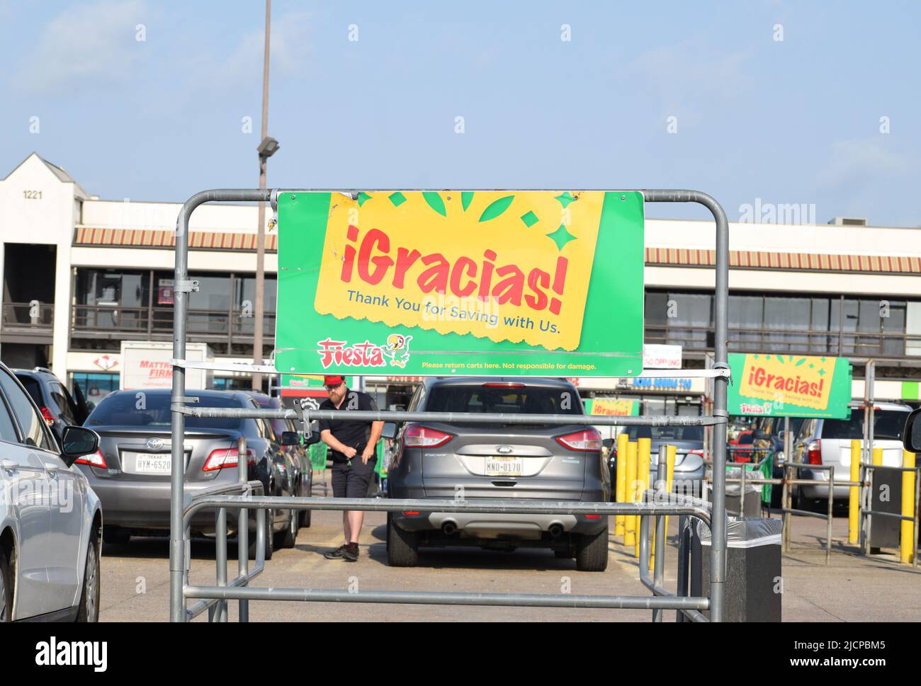 Grocery cart corral at a Fiesta grocery store in Texas, the word Gracias is prominent on the corral Stock Photo