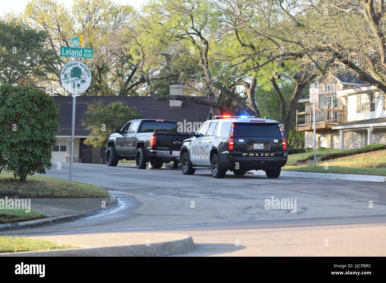 A police officer making an early morning traffic stop of a black Chevrolet Silverado pick up truck in Irving, Texas Stock Photo