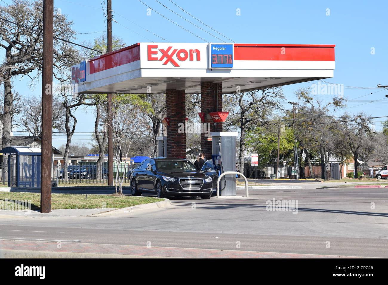 Woman preparing to pump gas at an Exxon gas station Stock Photo