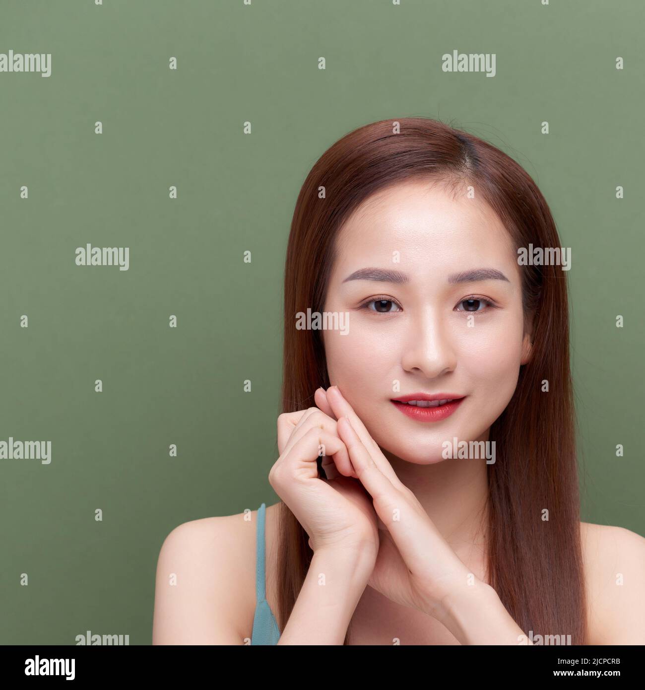 Beautiful young woman with silky skin after spa treatment on color background Stock Photo
