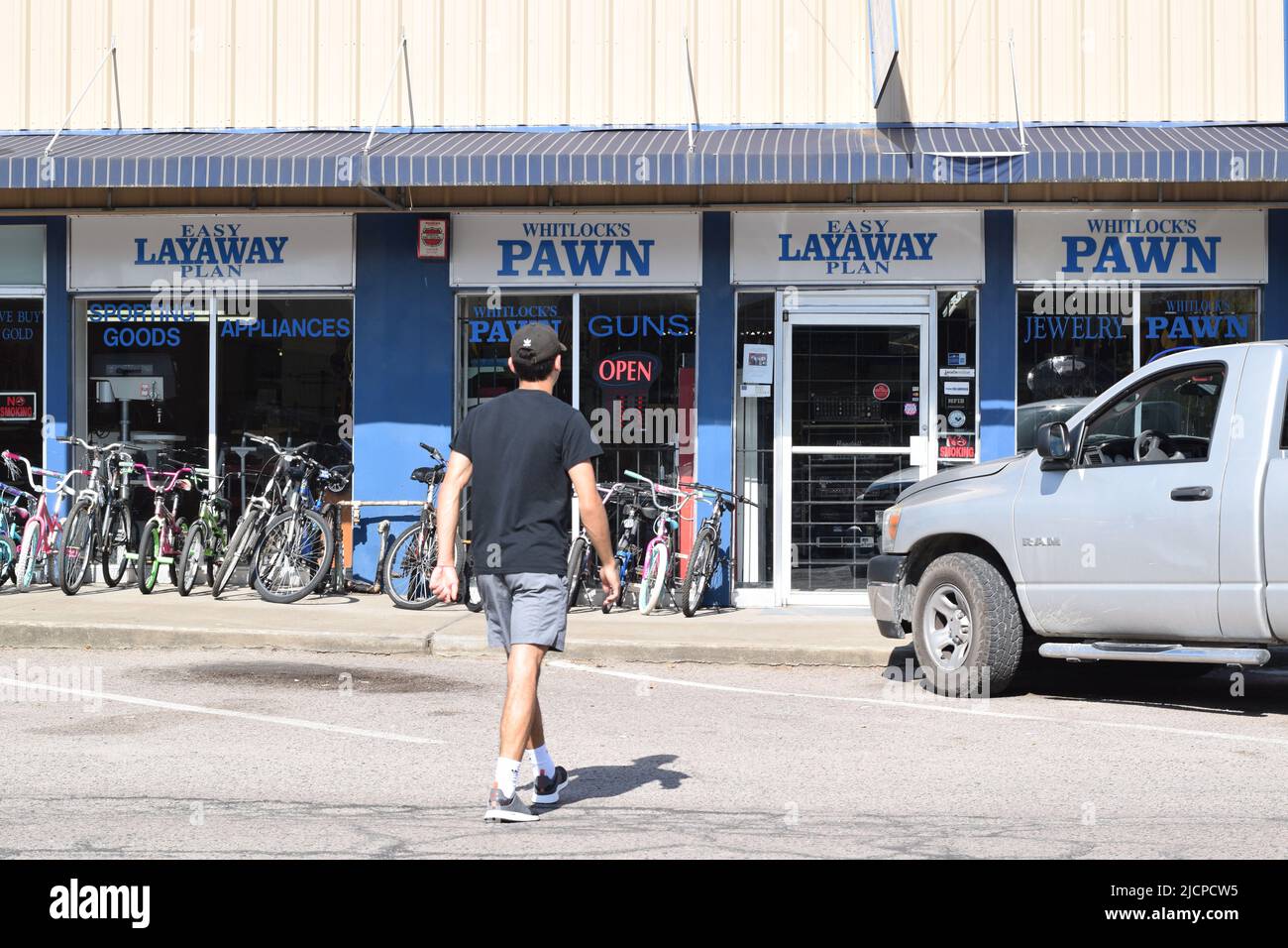 Generation Z (Gen Z) man walking into a pawn shop in Bonham, Texas Stock Photo