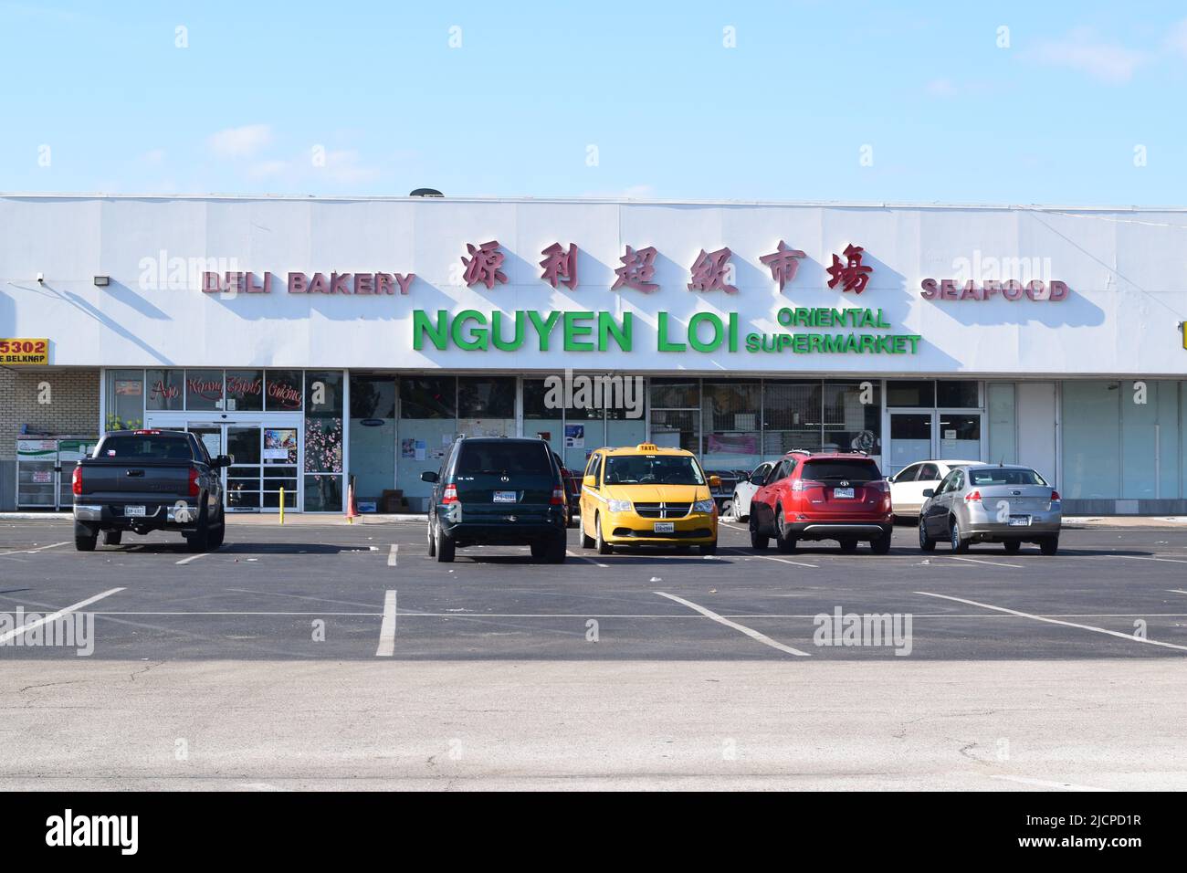 Cars in the parking lot of the Nguyen Loi Oriental Supermarket in Haltom City Texas Stock Photo