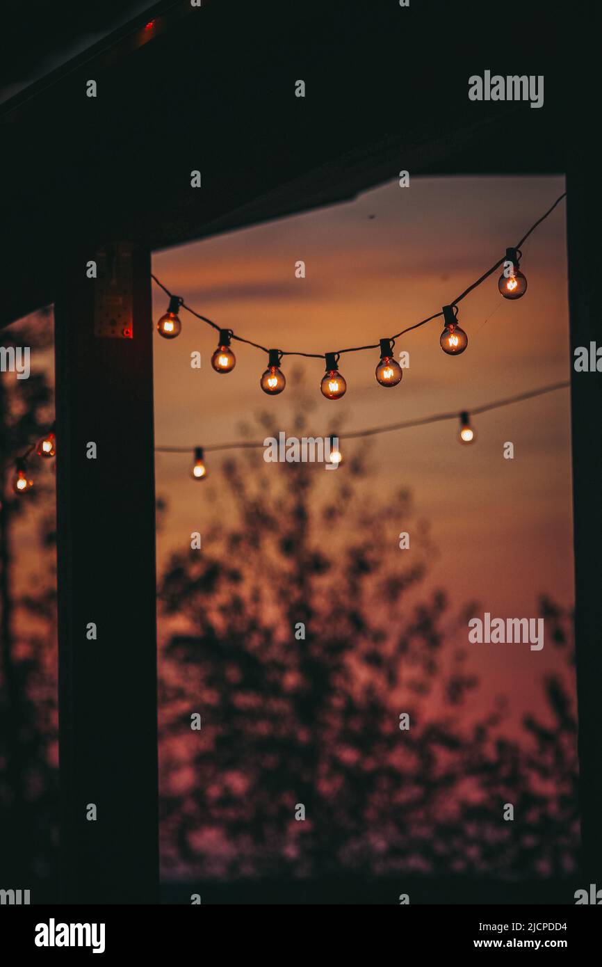 Fairy lights on a outdoor patio deck in the sunset Stock Photo Alamy