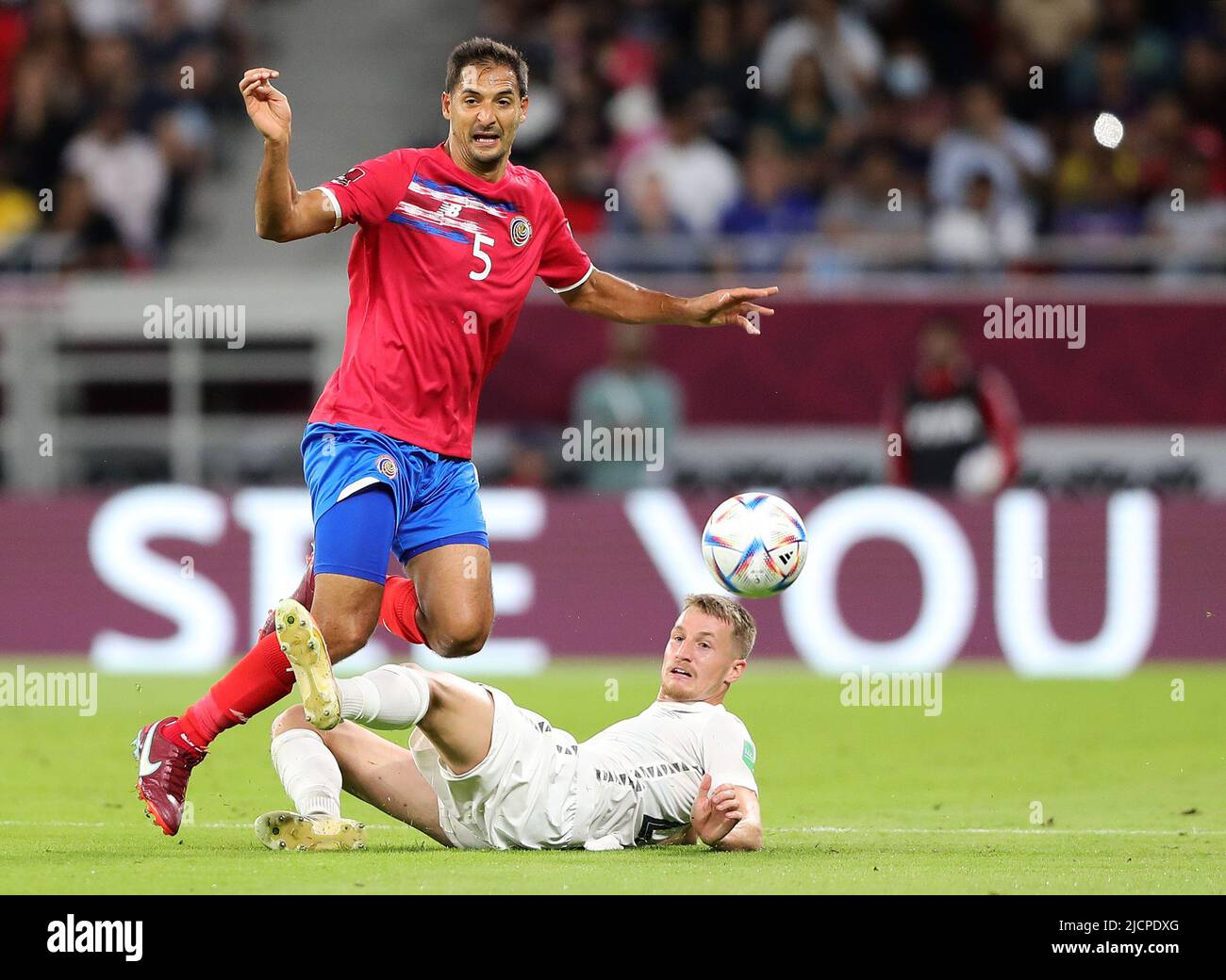 Doha, Qatar. 14th June, 2022. Celso Borges (L) of Costa Rica breaks through during the FIFA World Cup 2022 intercontinental play-offs match between Costa Rica and New Zealand at the Ahmed bin Ali Stadium, Doha, Qatar, June 14, 2022. Credit: Wang Dongzhen/Xinhua/Alamy Live News Stock Photo