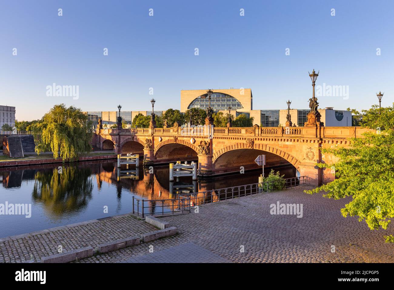 The stone Moltke (Moltkebrücke) bridge over Spree River in central district of Berlin with Federal Chancellery building in background, Germany Stock Photo