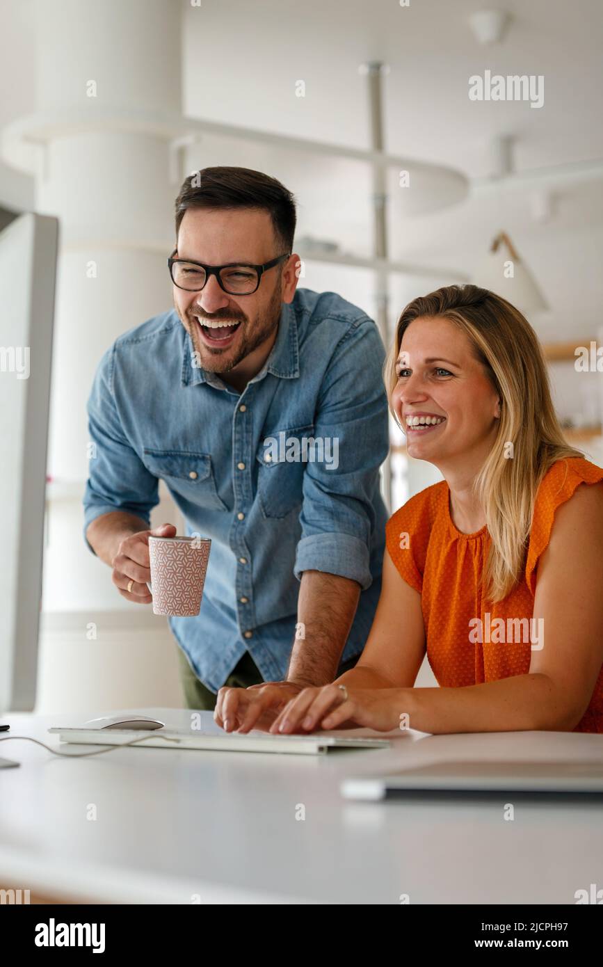 Programmers cooperating at IT company developing apps Stock Photo