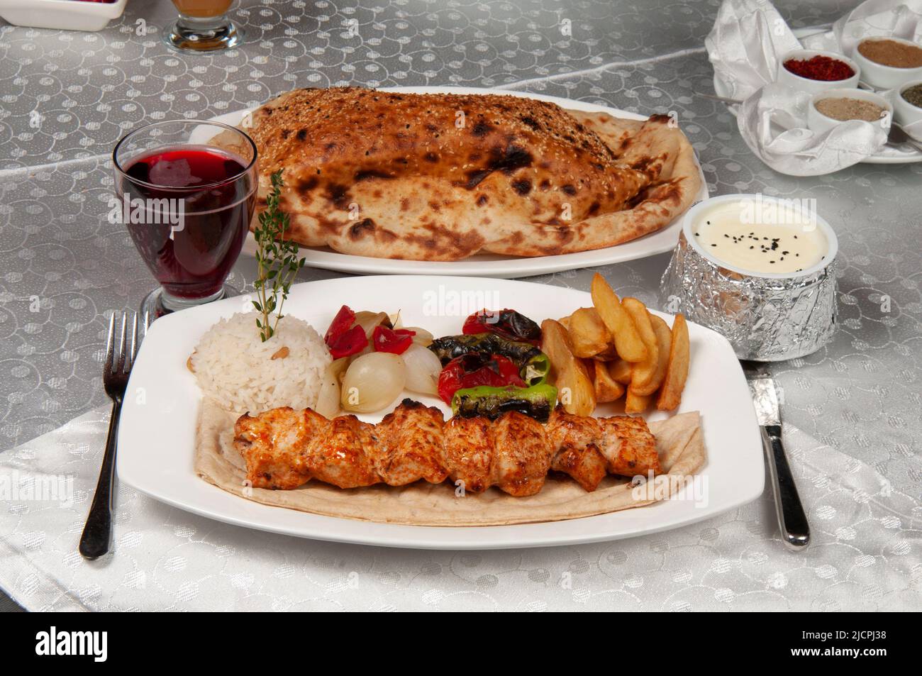 Shish kebab is chicken meat. There is shish kebab, pita bread and fruit ...