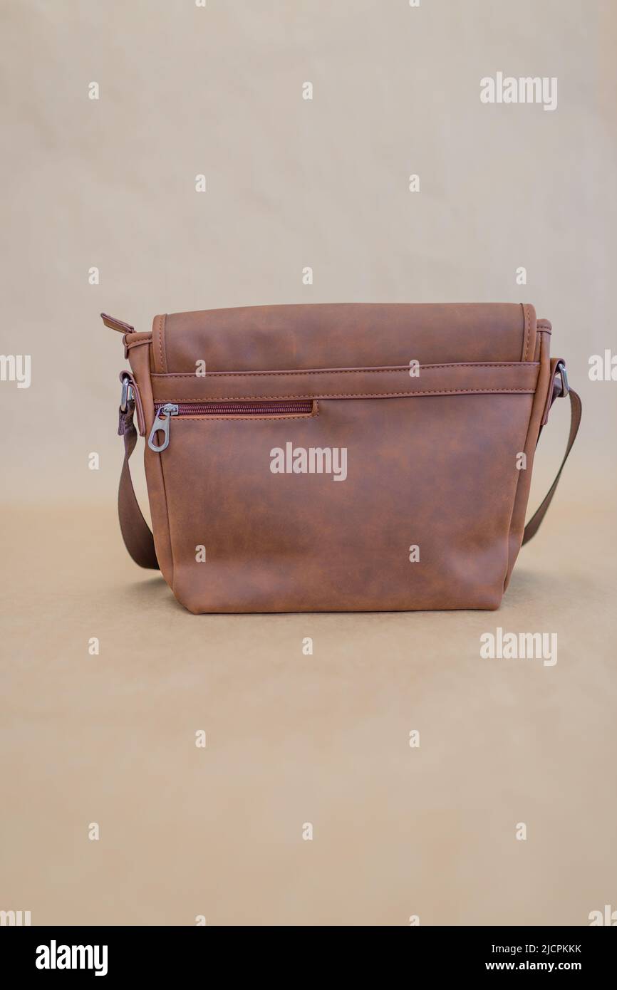 Leather messenger bag on a beige background Stock Photo Alamy