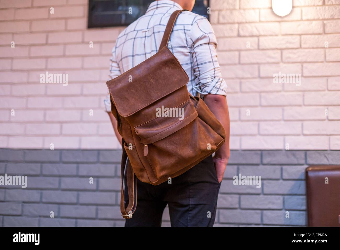 Back of man with brown leather backpack. Unisex bag for sale  display picture 2