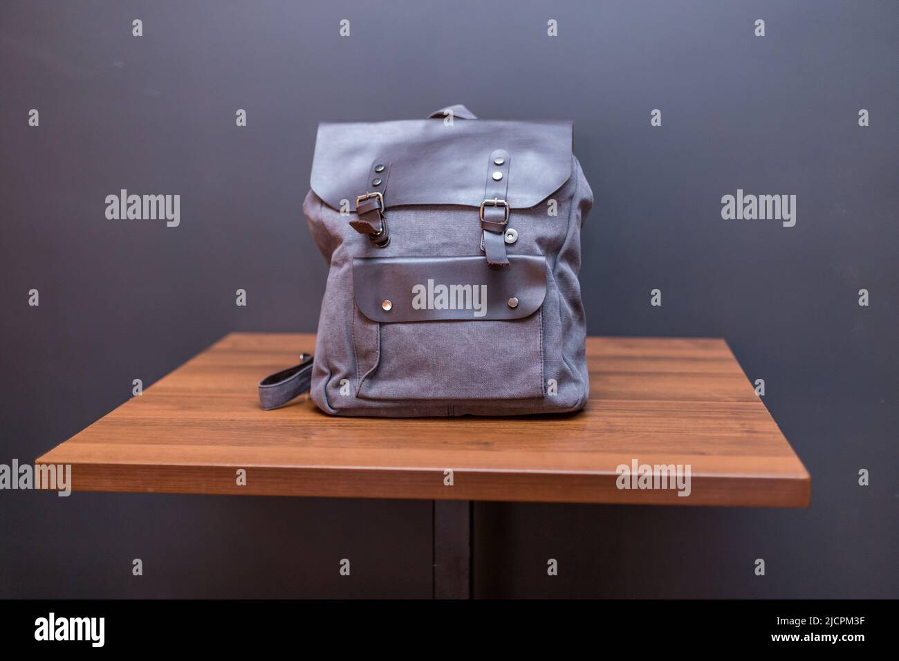 Canvas backpack on wood table. Unisex bag Stock Photo