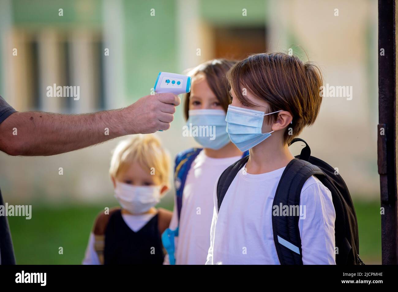 Teacher or medical person, controlling temperature and doing medical