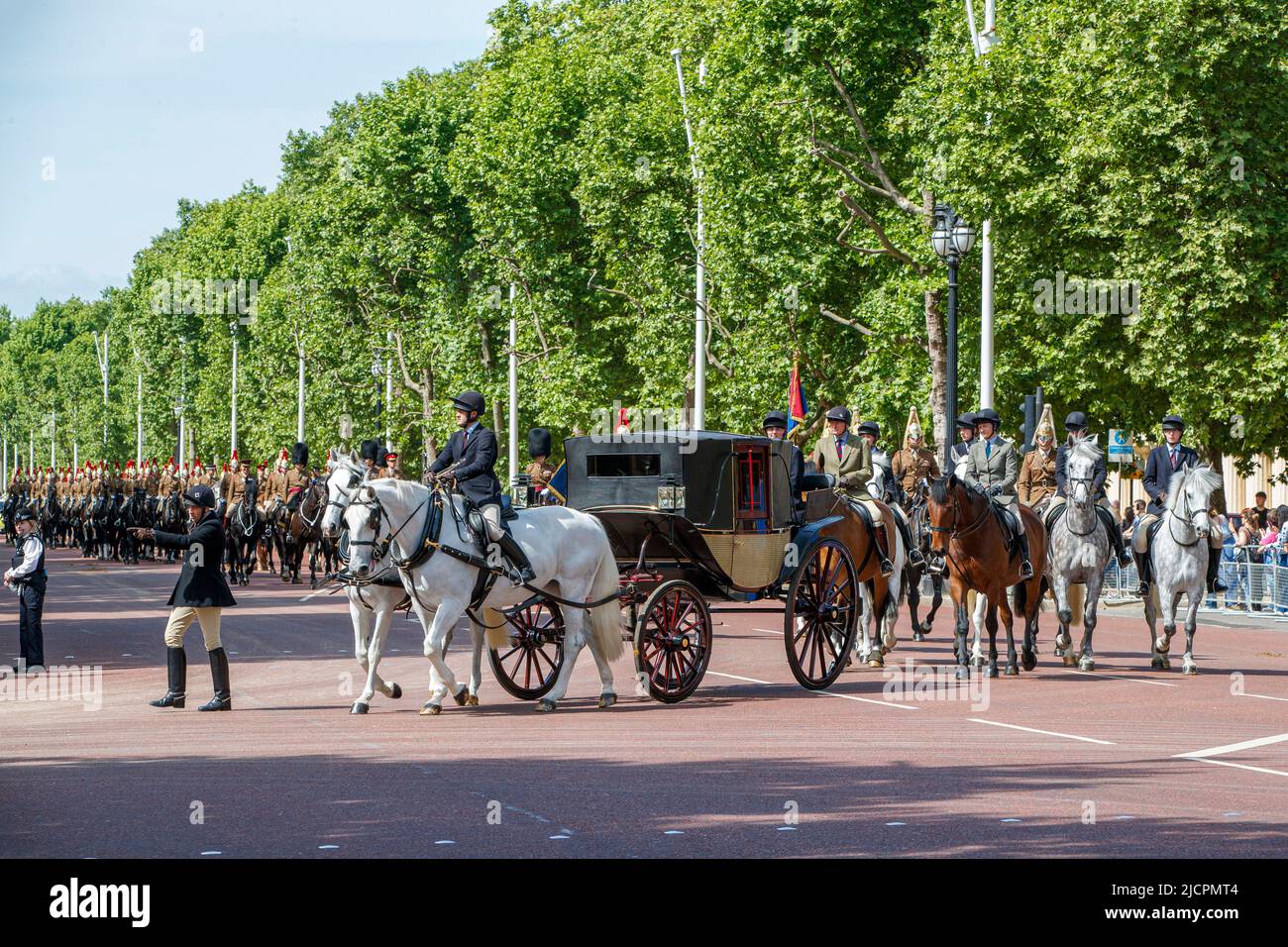 Queens Household Cavalry riding horses escorting a royal carriage along the Mall rehearsing for Trooping the Colour in London, England, United Kingdom Stock Photo