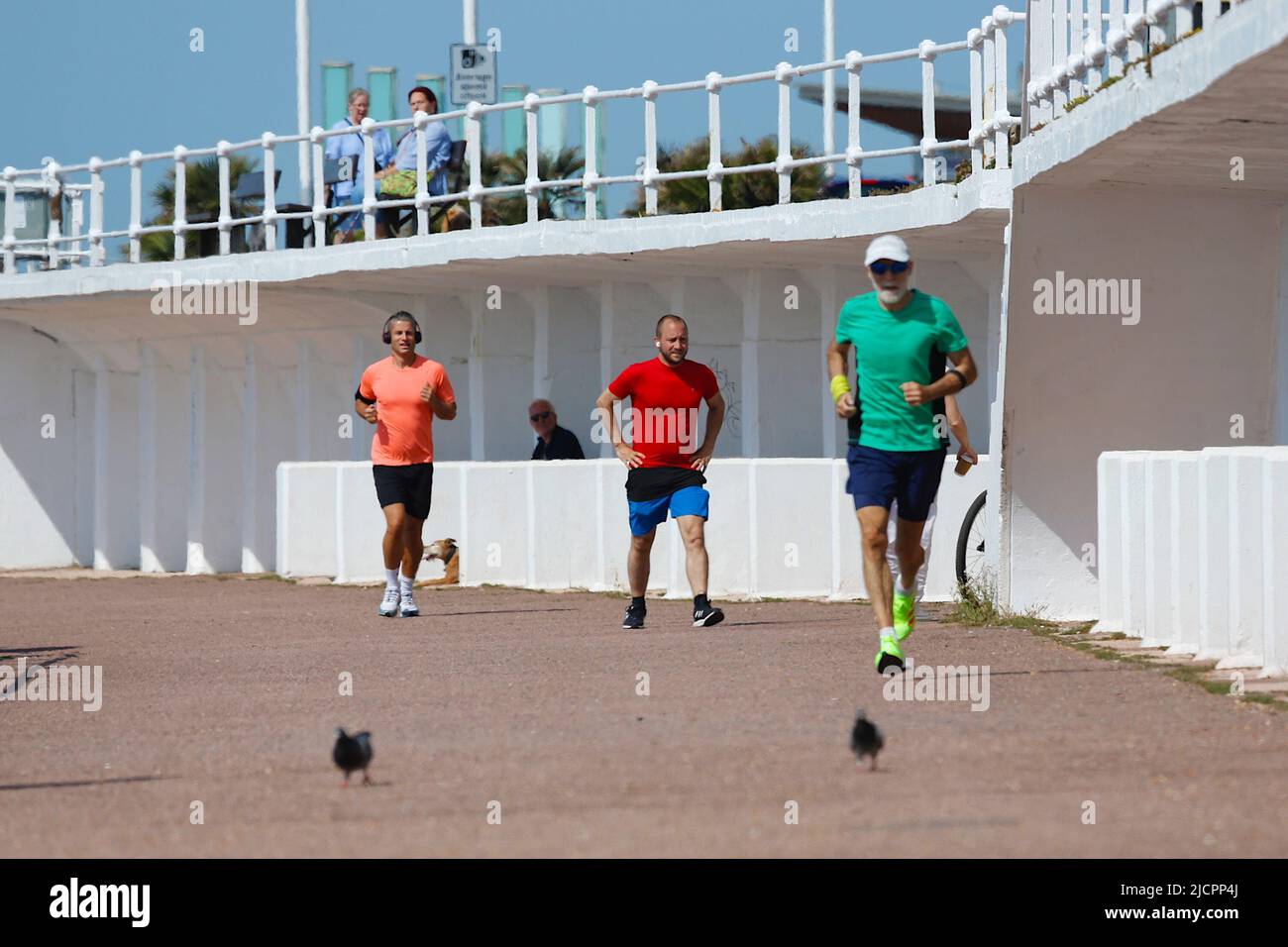 Hastings, East Sussex, UK. 15 Jun, 2022. UK Weather: Hot and sunny at the seaside town of Hastings in East Sussex as Brits enjoy the warm weather today along the seafront promenade. Joggers keep fit on the Hastings promenade. Photo Credit: Paul Lawrenson /Alamy Live News Stock Photo
