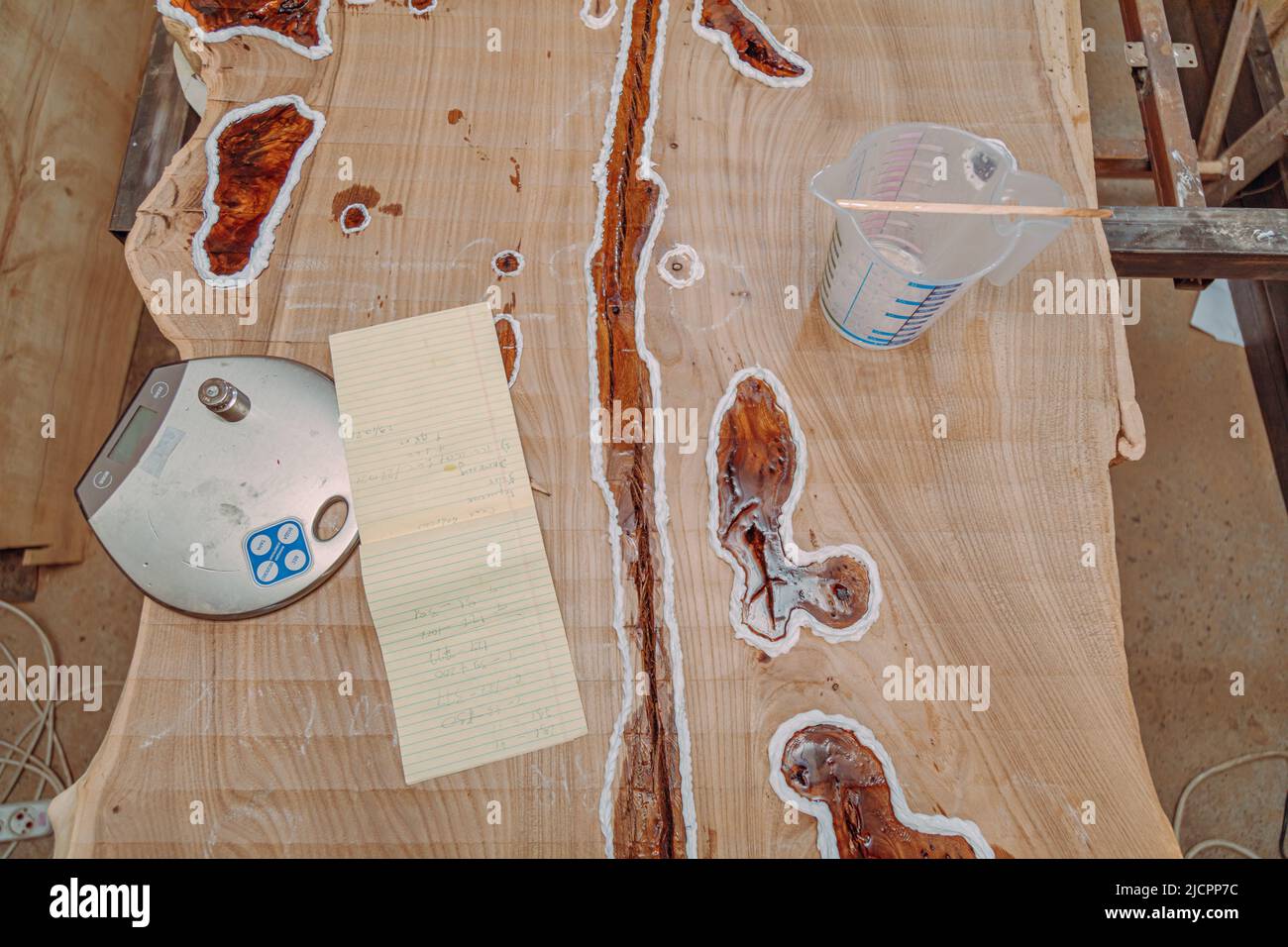 Dried epoxy resin in wood table, macro closeup. Process of making a
