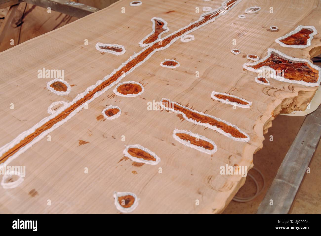Dried epoxy resin in wood table, macro closeup. Process of making a
