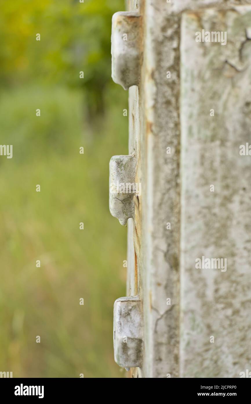 Screws on a high voltage pole, side view Stock Photo