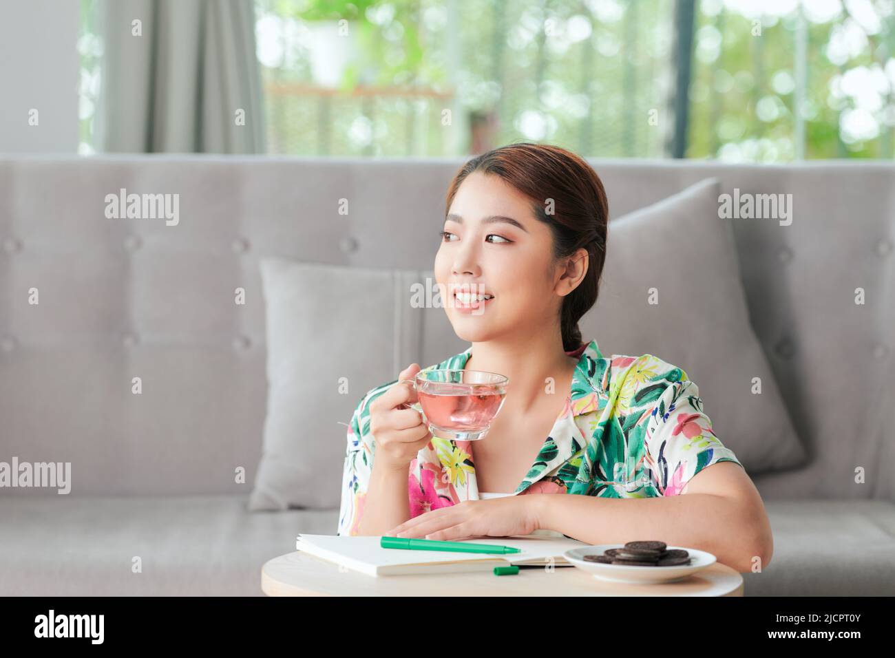 Smiling retired woman relaxing at home during quarantine Stock Photo