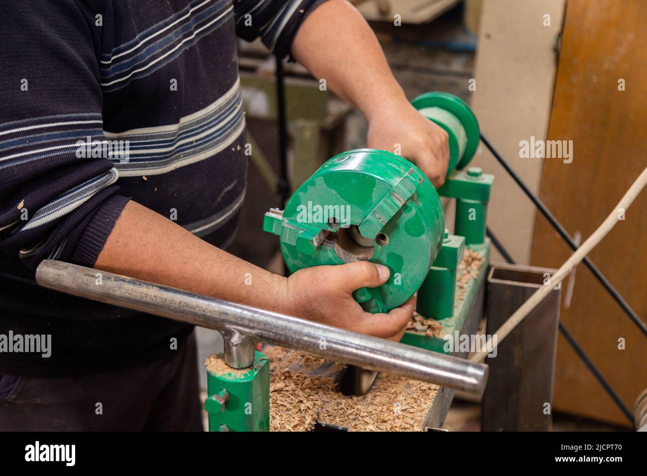 Carpenter preparing machine for turning wood on a lathe Stock Photo Alamy