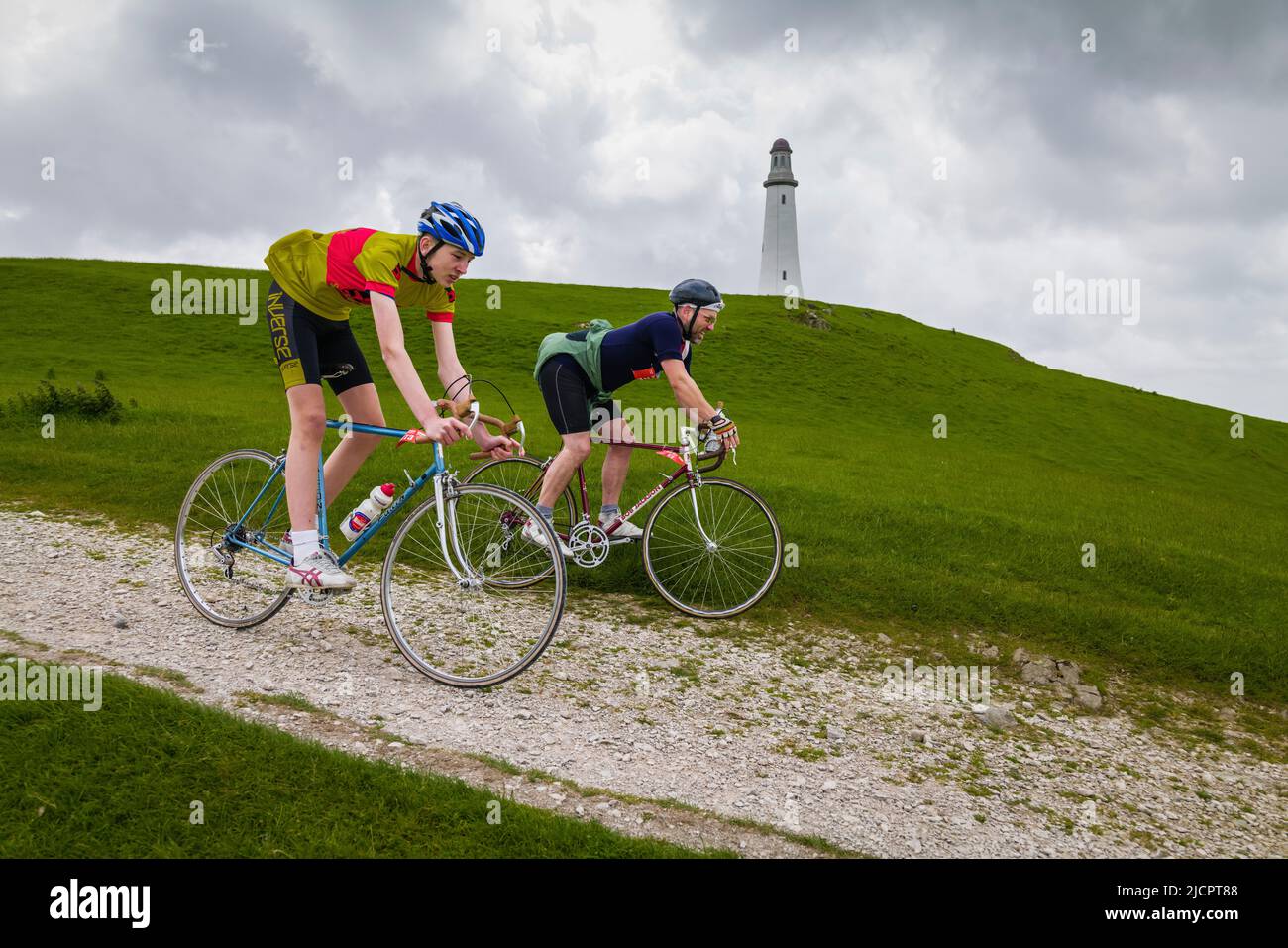 Vintage cyclist riding the gravel track to the Hoad monument in the Veloretro cycling event, Ulverston, Cumbria, UK. Stock Photo