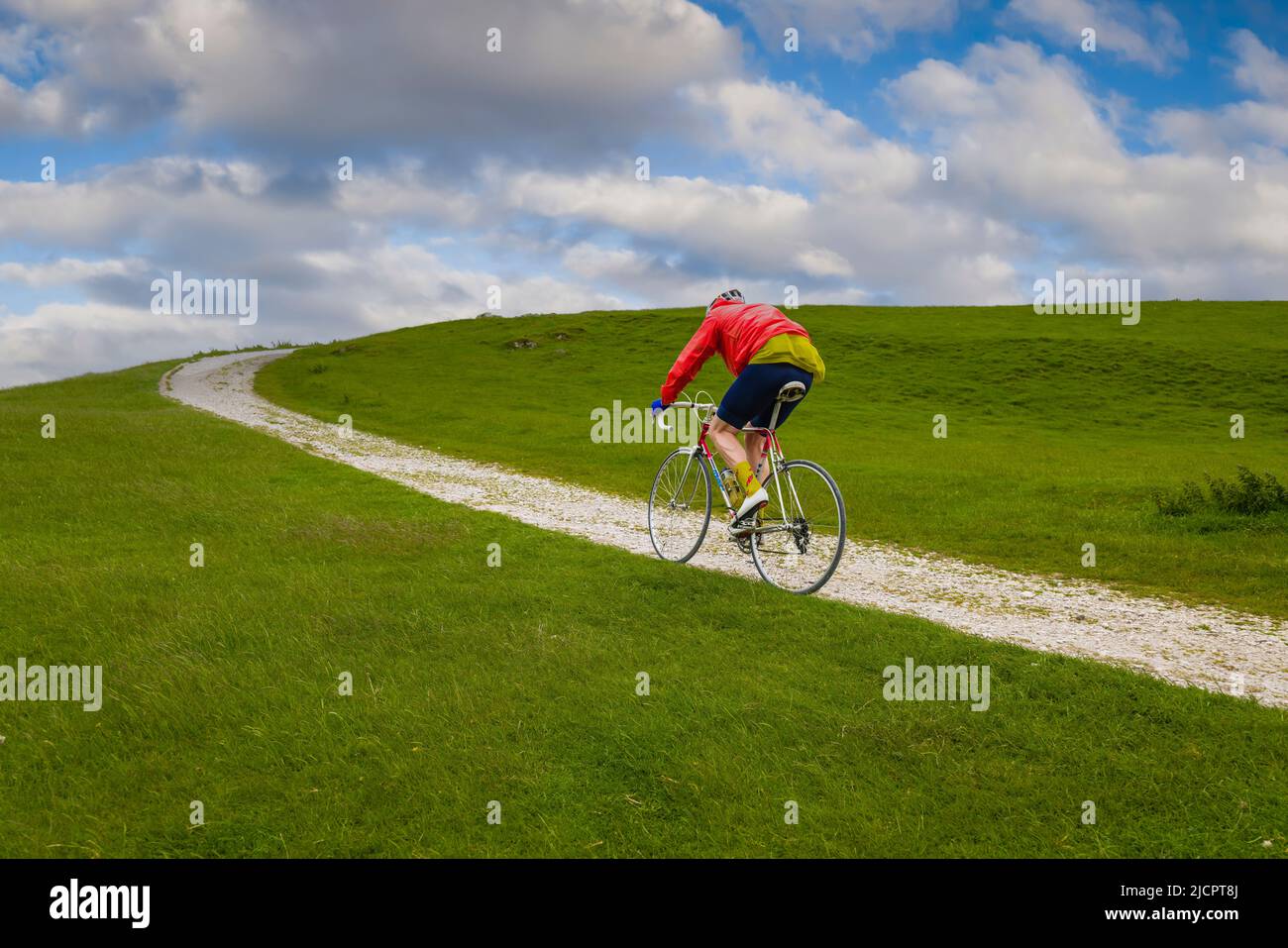 Vintage cyclist riding the gravel track to the Hoad monument in the Veloretro cycling event, Ulverston, Cumbria, UK. Stock Photo