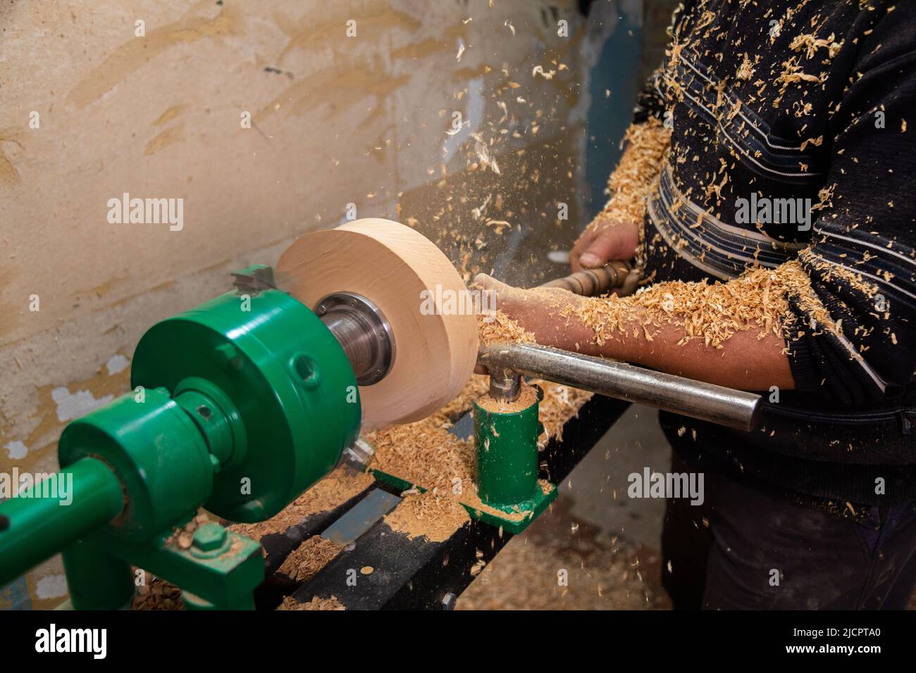 Carpenter turning wood on a lathe. Person carving chisel candlestick on a lathe Stock Photo Alamy