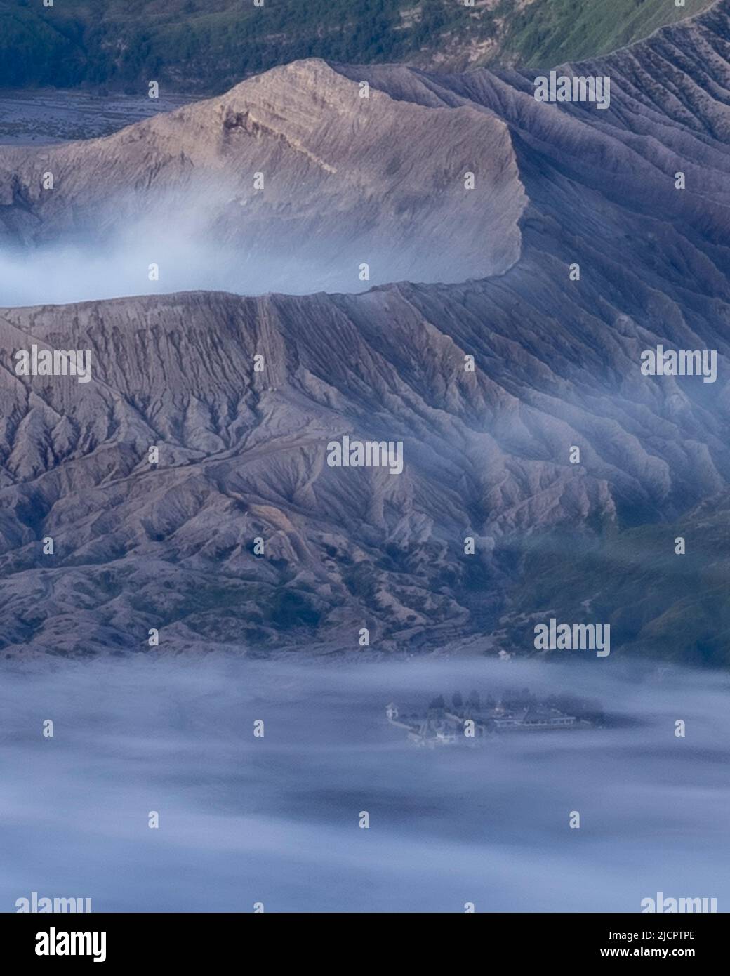 Mount Bromo and Luhur poten temple on foggy morning Stock Photo