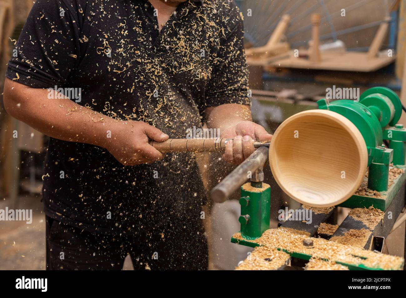 Carpenter turning wood on a lathe. Person carving chisel candlestick on a lathe Stock Photo Alamy