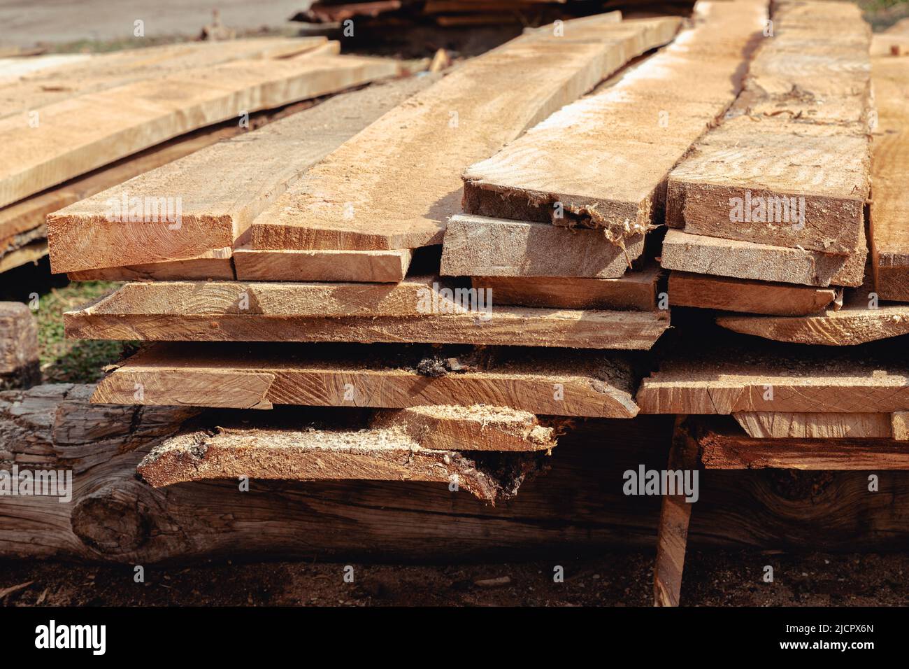 Stacked lumber. Folded wood.Closeup wooden boards. Wood planks stacked