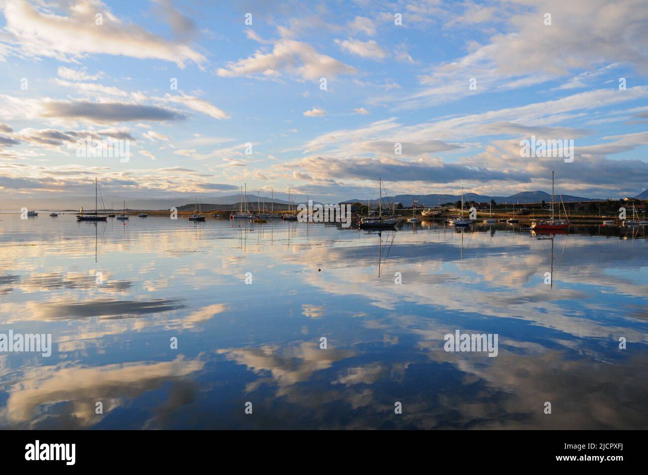 Boats in the harbor with sky reflection on water Stock Photo - Alamy