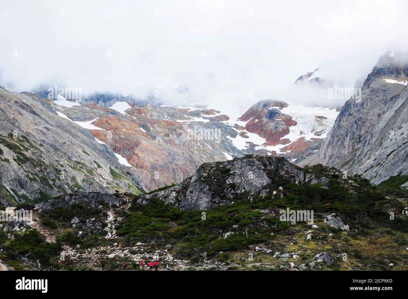 Group of people hiking in the mountains Stock Photo - Alamy