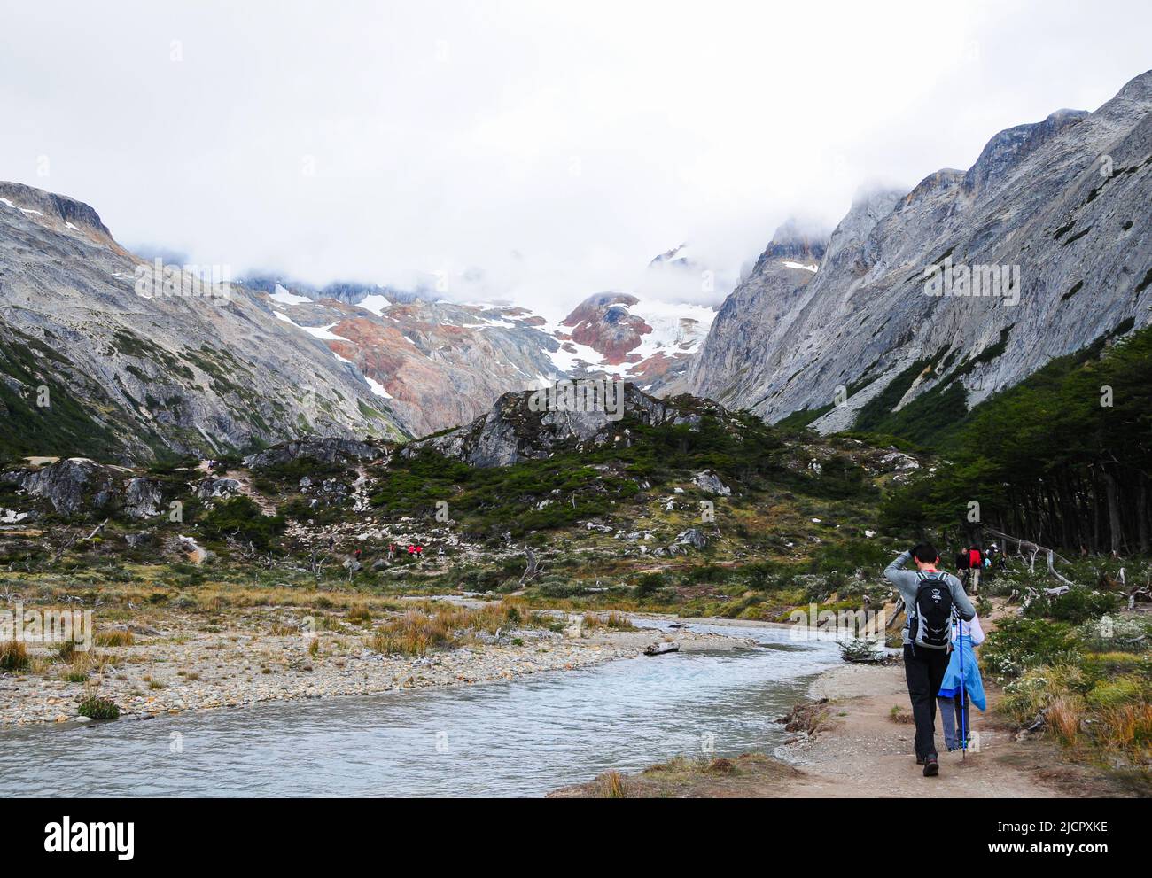 Group of people hiking in the mountains Stock Photo - Alamy