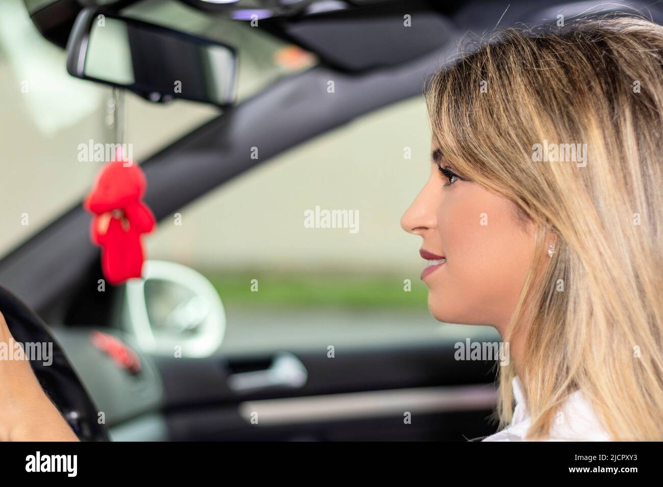 blonde woman driving without seat belt Stock Photo