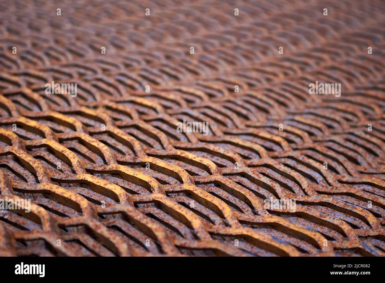 Perforated rusty metal sheet stamping plates texture closeup angled view. Made through metal