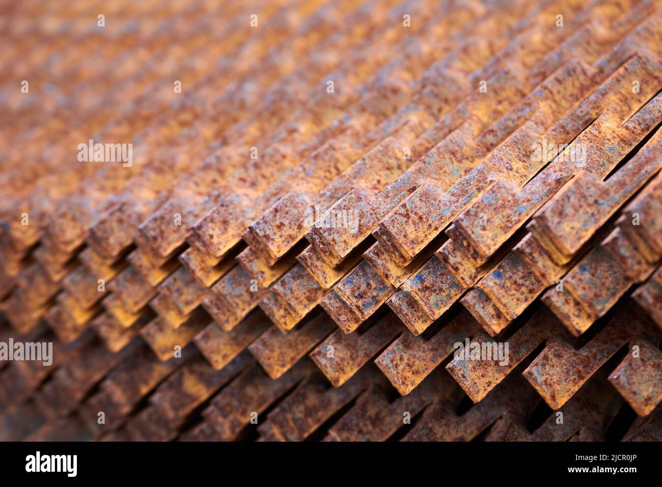 Perforated rusty metal sheets stamping plates texture closeup side view. Made through metal
