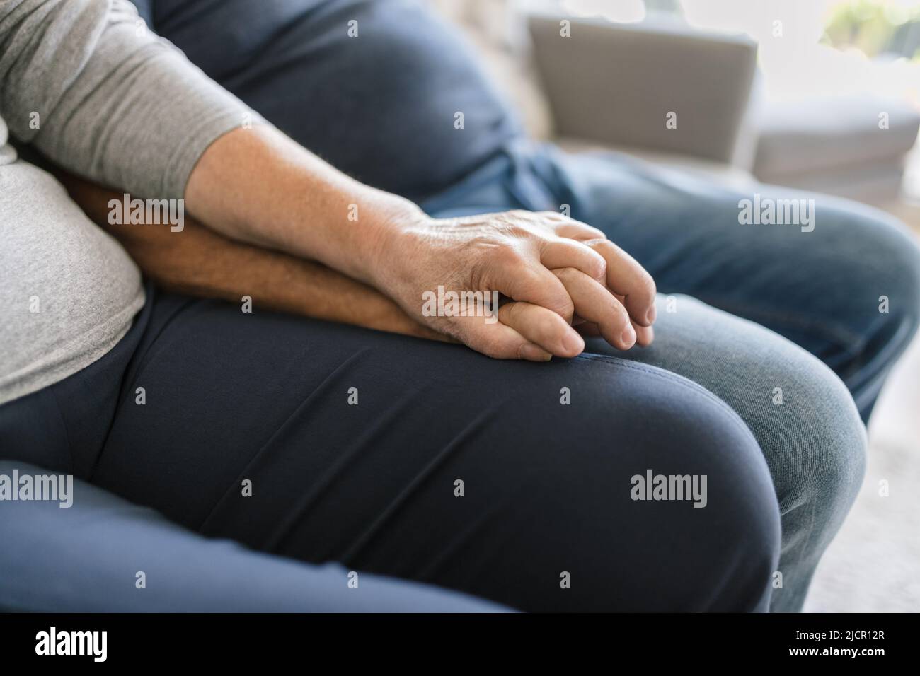 Happy romantic senior couple in love holding hands at home Stock Photo