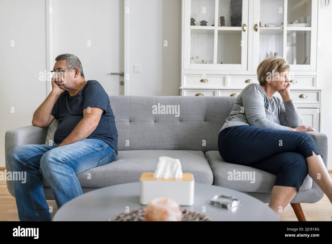 Upset senior couple at home in living room having an argument Stock Photo
